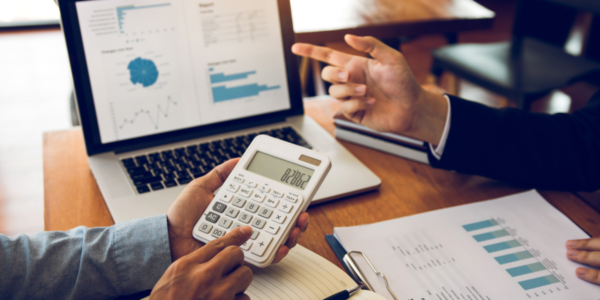 Business professionals calculating their company's profit using a calculator, emphasizing financial analysis and decision-making.